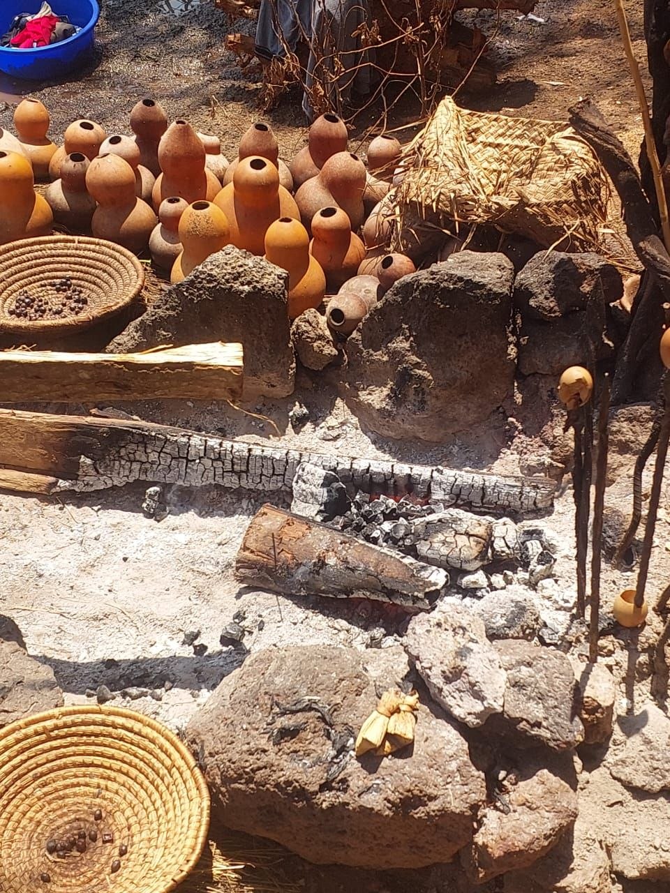 Carved gourds, woven baskets and a ceremonial fire prepared for a marriage rite